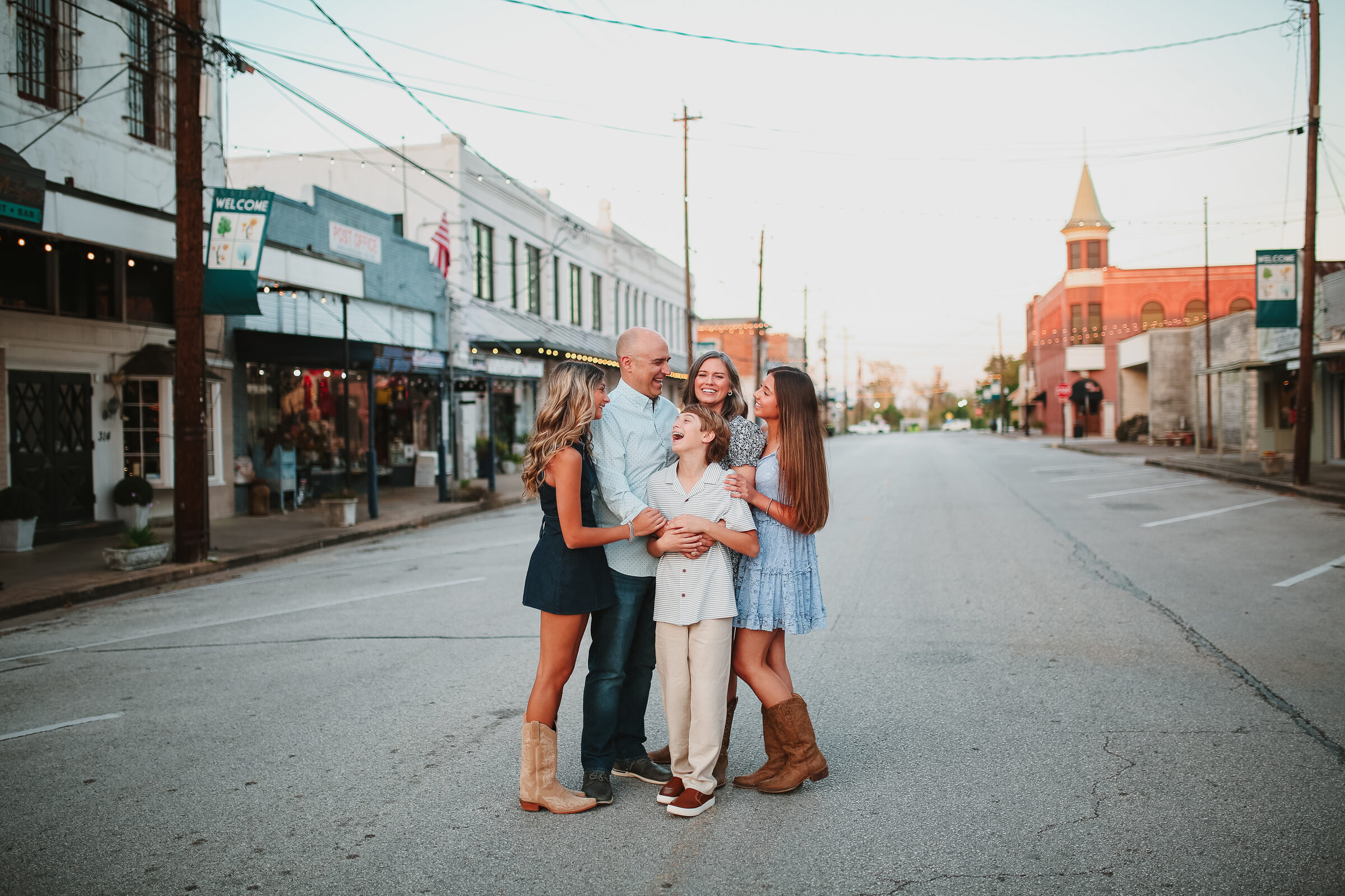 A family gathered together on a charming small-town street at golden hour