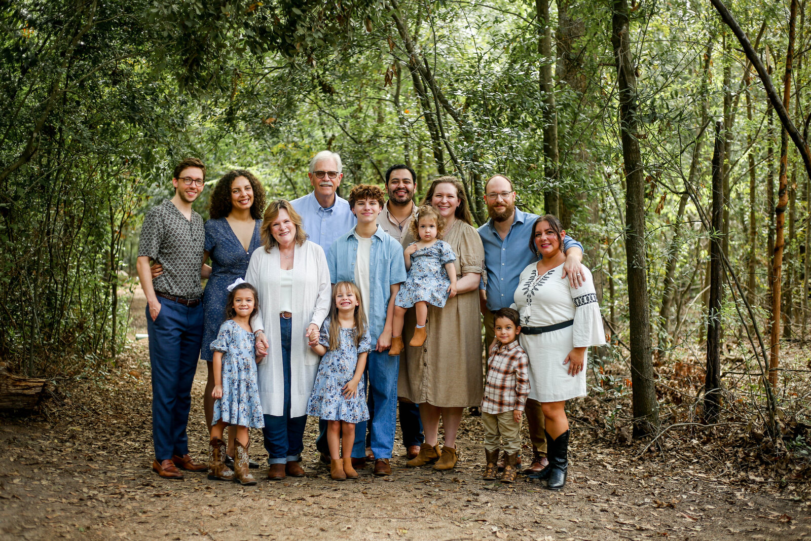 Three generations together on a wooded trail