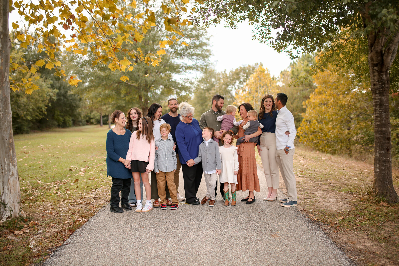 The extended family lined up along a path in the fall color